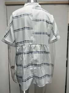 Back detail of the loose white short-sleeve shirt with blue tribal striped pattern.
