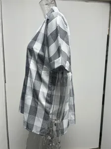 Detail view of a casual black and white plaid short sleeve shirt showcasing the V-neck and fit.