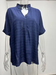 Detail view of the casual dark blue short-sleeve V-neck blouse texture and neckline design.