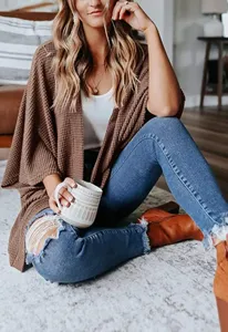 Detail view of women waffle knit cardigan lifestyle outfit showcasing casual autumn style.