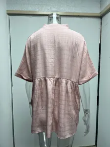 Back view detail of a loose pink short-sleeve blouse with subtle plaid texture for women.