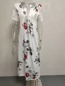 Detail view of women floral print long dress with lace short sleeves and buttons for summer.