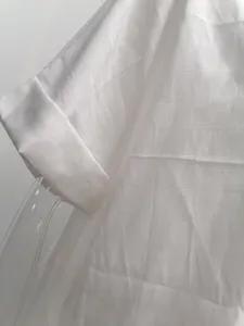 Detail view of women's summer short sleeve white textured loose shirt, casual fashion style.