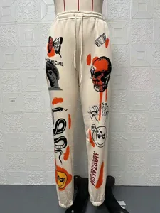 Fleece-lined high-waisted casual sweatpants with cool graphic skull print street style.