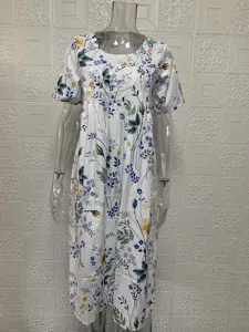 Floral print short sleeve dress detail showing round neck, pleated front and swing hem.