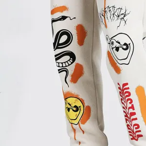 Detail shot of fleece-lined casual sweatpants with trendy streetwear graffiti and snake prints.