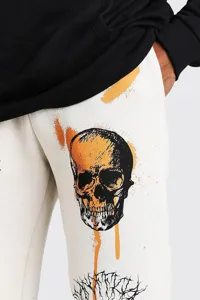 Detailed view of women's casual fleece sweatpants featuring bold skull and graffiti print.