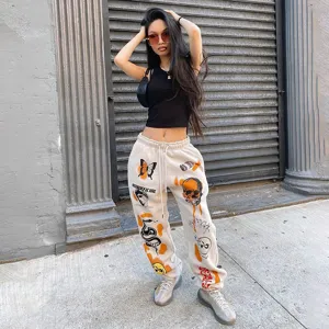 Trendy streetwear fleece-lined high-waisted casual sweatpants with cool skull graffiti print.