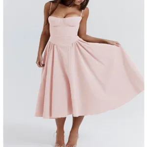 Gros plan détaillé de la robe bustier rose, mettant en valeur le corsage et la jupe.