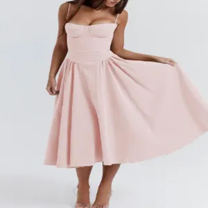 Robe midi rose style corset avec bretelles fines et jupe trapèze évasée pour la mode d'été.
