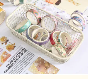 Decorative washi tape set in storage basket for DIY journaling and crafting projects detail view.