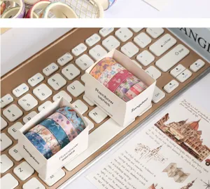 Detailed shot of retro washi tape rolls in packaging boxes, perfect for DIY journaling crafts.