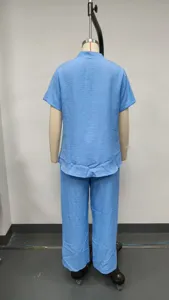 Back view details of casual light blue short sleeve shirt and wide leg trousers set.