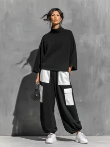 Detailed view of stylish black cargo pants featuring white contrast pockets and top.