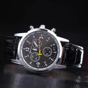 Detail view of men quartz watch with black leather strap and dark chronograph dial.