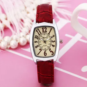 Detailed view of the women quartz watch with red leather strap and tonneau dial.