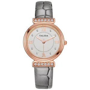Detail view of women quartz watch with grey strap rose gold case and rhinestone lugs.