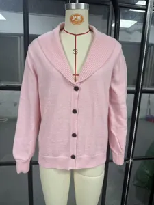 Detailed view of the pink knitted cardigan, highlighting the elegant shawl collar and button closure.