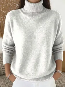 Detail view of the soft knitted turtleneck sweater texture and cozy fabric closeup.