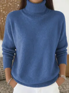 Close-up detail of the cozy blue turtleneck knit sweater, showing soft texture and fine stitching.