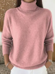 Closeup view of pink knit turtleneck sweater with soft ribbed collar for daily casual winter wear.