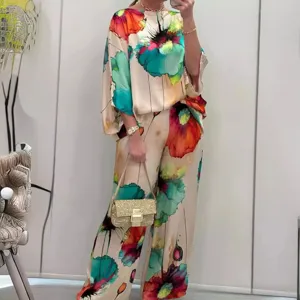 Elegant floral satin matching set featuring a loose boat neck top and wide-leg trousers.