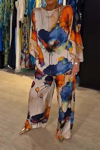 Detail shot of the elegant satin abstract floral print loose batwing top and trousers set.