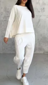 Detail view of the casual white long-sleeve sweatshirt and matching harem pants outfit.