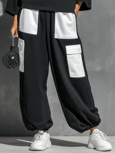 Women's black and white contrast two-piece outfit with long sleeve top and cargo pants detail.