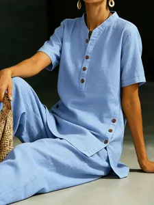 Detailed shot of casual linen two-piece set featuring a light blue button shirt and wide-leg pants.