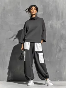Detailed view of the women's dark grey turtleneck sweater and contrast pocket cargo pants.