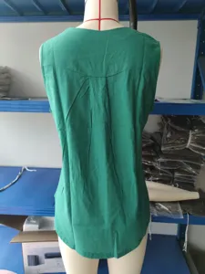 Back view detail of the green sleeveless casual linen shirt featuring pleated design.