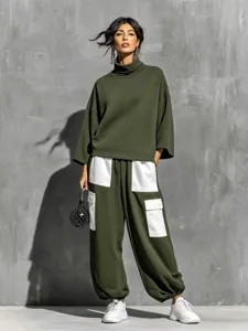 Detailed view of women's olive green turtleneck sweatshirt and white pocket cargo pants outfit.
