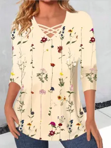 Detail view of floral print long sleeve t-shirt featuring trendy criss cross v neck.