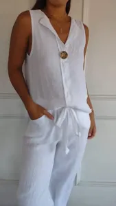 Detailed shot of the white linen sleeveless V-neck top and matching casual pants set.