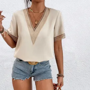Close-up of the elegant V-neck blouse featuring delicate lace trim details on short sleeves.