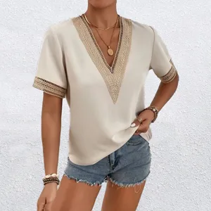 Detailed view of women's beige V-neck short sleeve top with elegant lace trim details.