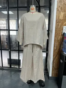 Detailed shot of casual linen blend batwing sleeve top and wide leg pants set in beige.