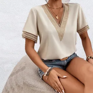 Detailed view of elegant V-neck short sleeve blouse featuring intricate lace trim design.