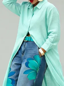 Close-up view of the stylish mint green button-up shirt and floral print denim jeans set.
