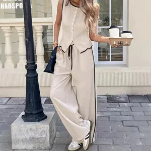 Elegante completo da donna con gilet bottonato e pantaloni larghi con bordi a contrasto.