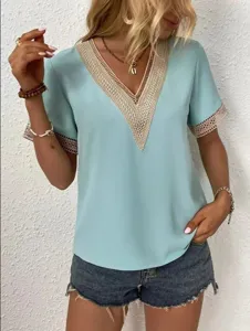 Detail shot of light blue short-sleeve top with elegant V-neck and delicate lace trim design.