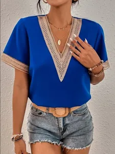 Royal blue V-neck short sleeve top detail showcasing delicate beige lace trim and elegant design.