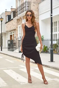 Black satin cowl neck side drawstring irregular strap dress detail view showcasing texture.