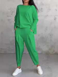 Green long sleeve sweatshirt and harem pants set for women, casual two piece outfit.