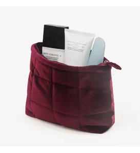 Large capacity velvet quilted cosmetic bag with zipper closure for travel and daily makeup storage.