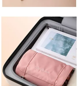 Pink hanging travel toiletry bag roll-up cosmetic organizer for women travel packing.