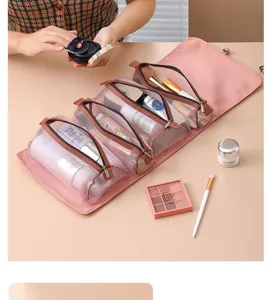 Detailed view of the pink hanging roll-up cosmetic bag with multi-compartment mesh pockets.