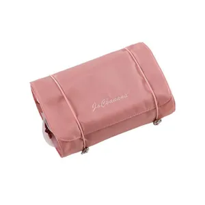 Pink travel cosmetic bag roll-up hanging toiletry organizer with secure elastic bands.