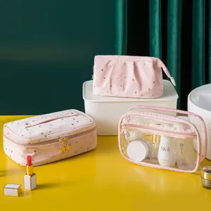 Pink velvet cosmetic bag set with gold stars and clear makeup organizer pouch for travel.